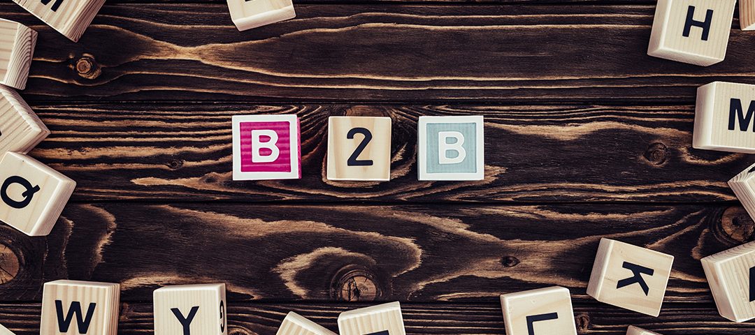 flat lay with b2b inscription made of blocks on brown wooden tabletop