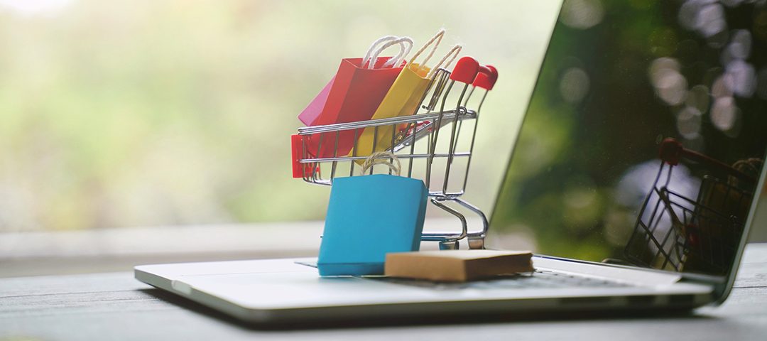 E-commerce shopping online concept, shopping bag in cart on computer laptop with copy space, black friday sale